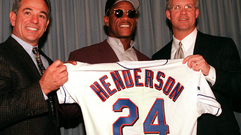 Mets Coach Bobby Valentine, left, and General Manager Steve Philips, right, introduce "stolen base king" Rickey Henderson, at a news conference given by the Mets at Shea Stadium in New York, Monday, Dec. 21, 1998. The Mets signed Henderson for $2.3 million for one year with an option for a second. (AP Photo/Ed Bailey)